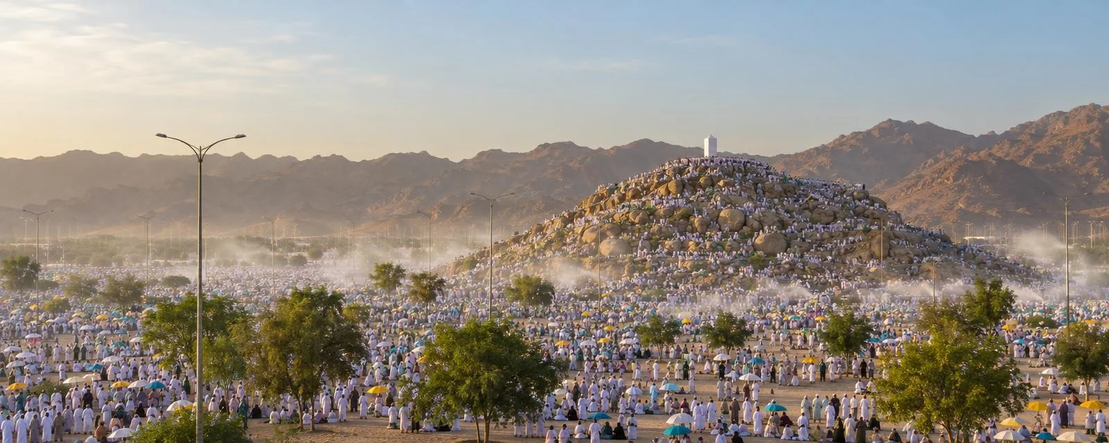 The plain of Arafat on the Day of Arafah, with Jabal al-Rahmah and pilgrims in white