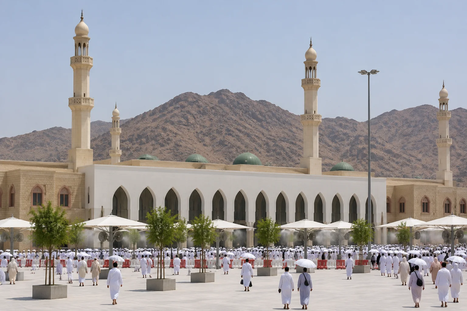 Masjid Namirah at Arafat, with its pointed arches, minarets and green domes, pilgrims in its courtyard